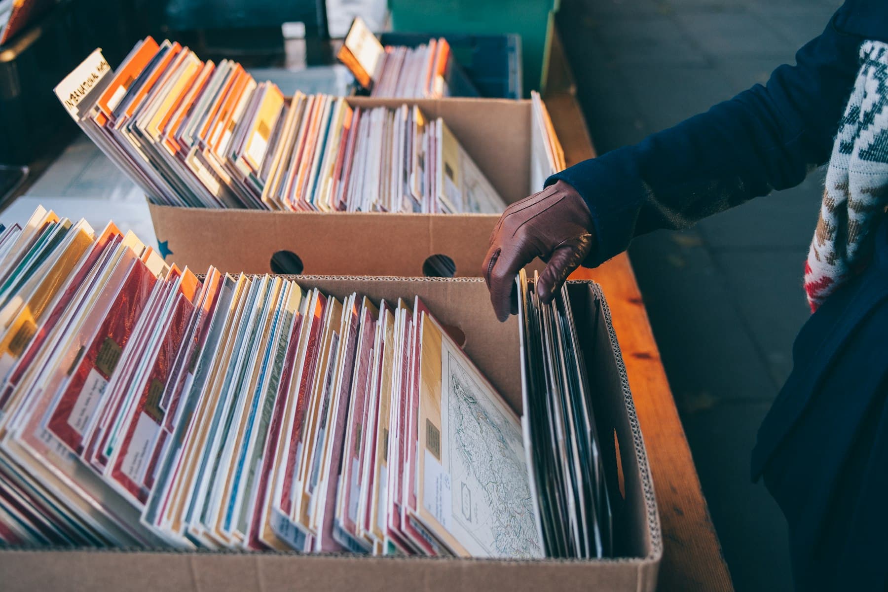 Crates of used records in cardboard boxes